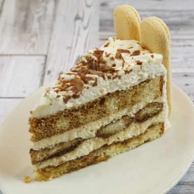 savor the classic flavor of a traditional tiramisu slice at Mia's Bakery.