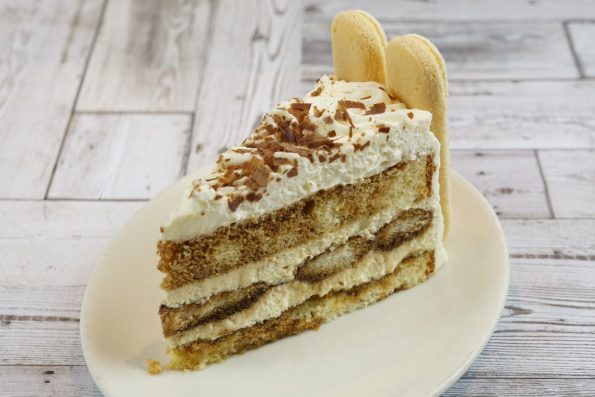 savor the classic flavor of a traditional tiramisu slice at Mia's Bakery.