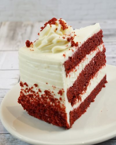 savor the classic flavor of a traditional red velvet cake slice at Mia's Bakery.