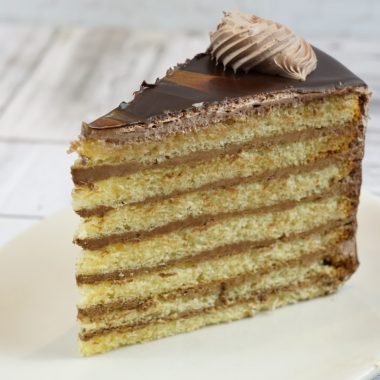 savor the classic flavor of our traditional 7 layer cake slice at Mia's Bakery.