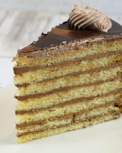 savor the classic flavor of our traditional 7 layer cake slice at Mia's Bakery.