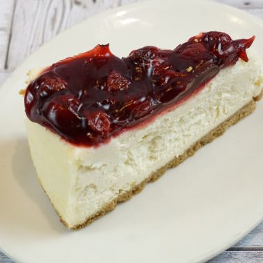 savor the classic flavor of a traditional New York style cherry cheesecake slice at Mia's Bakery.