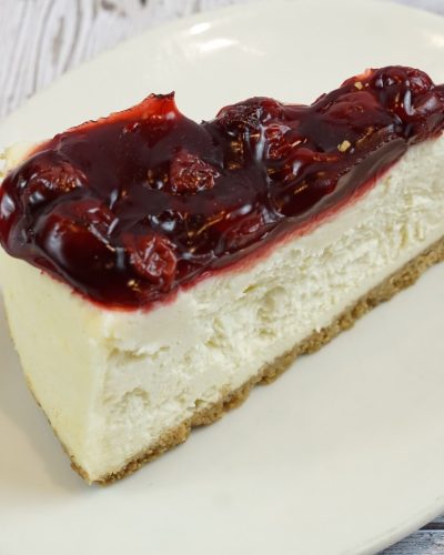 savor the classic flavor of a traditional New York style cherry cheesecake slice at Mia's Bakery.