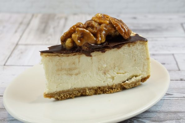 savor the classic flavor of a traditional New York style pecan pie cheesecake slice at Mia's Bakery.