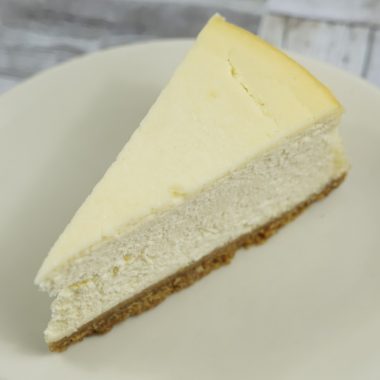 savor the classic flavor of a traditional New York cheesecake slice at Mia's Bakery.