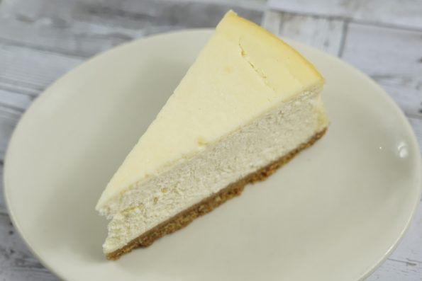 savor the classic flavor of a traditional New York cheesecake slice at Mia's Bakery.