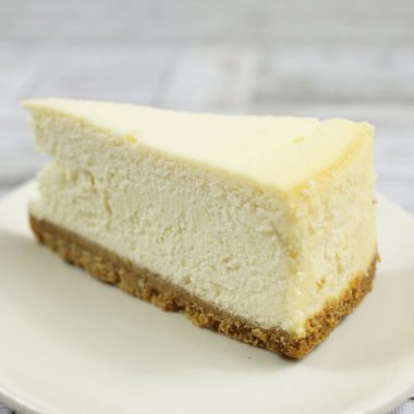 savor the classic flavor of a traditional New York cheesecake slice at Mia's Bakery.