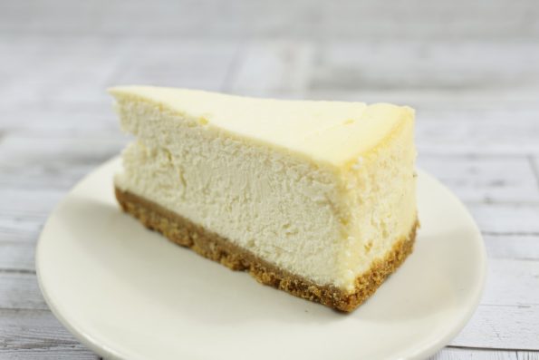 savor the classic flavor of a traditional New York cheesecake slice at Mia's Bakery.