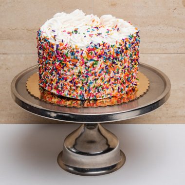 savor the classic flavor of a traditional rainbow cake at Mia's Bakery.