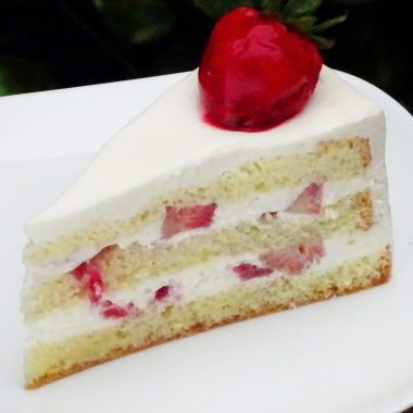 savor the classic flavor of a homemade strawberry shortcake cake slice at Mia's Bakery.