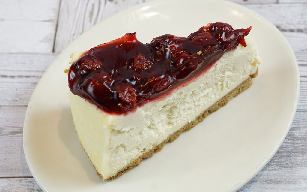 No-bake cherry cheesecake slice with graham cracker crust as easy 4th of July dessert ideas option