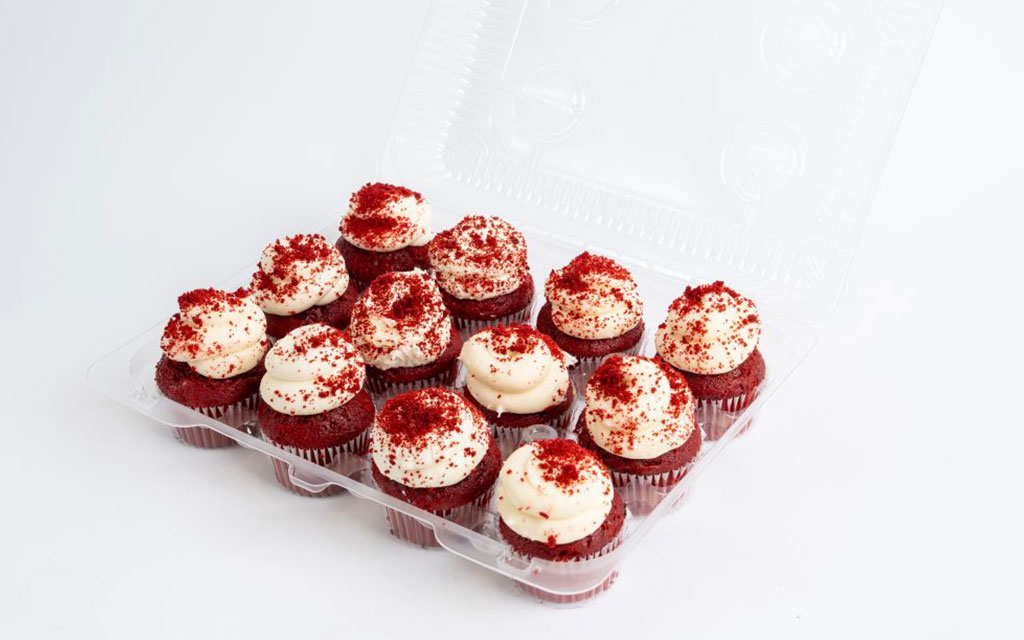 Mother's Day dessert ideas with red velvet cupcakes topped with cream cheese frosting and sprinkles