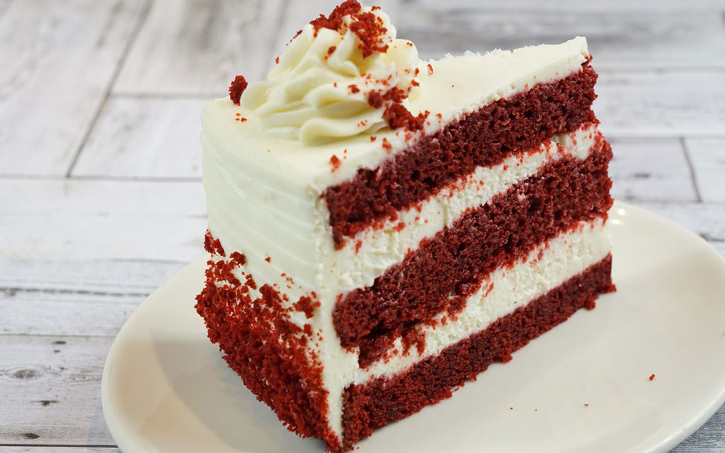 Mother's Day dessert idea featuring a slice of red velvet layer cake with cream cheese frosting