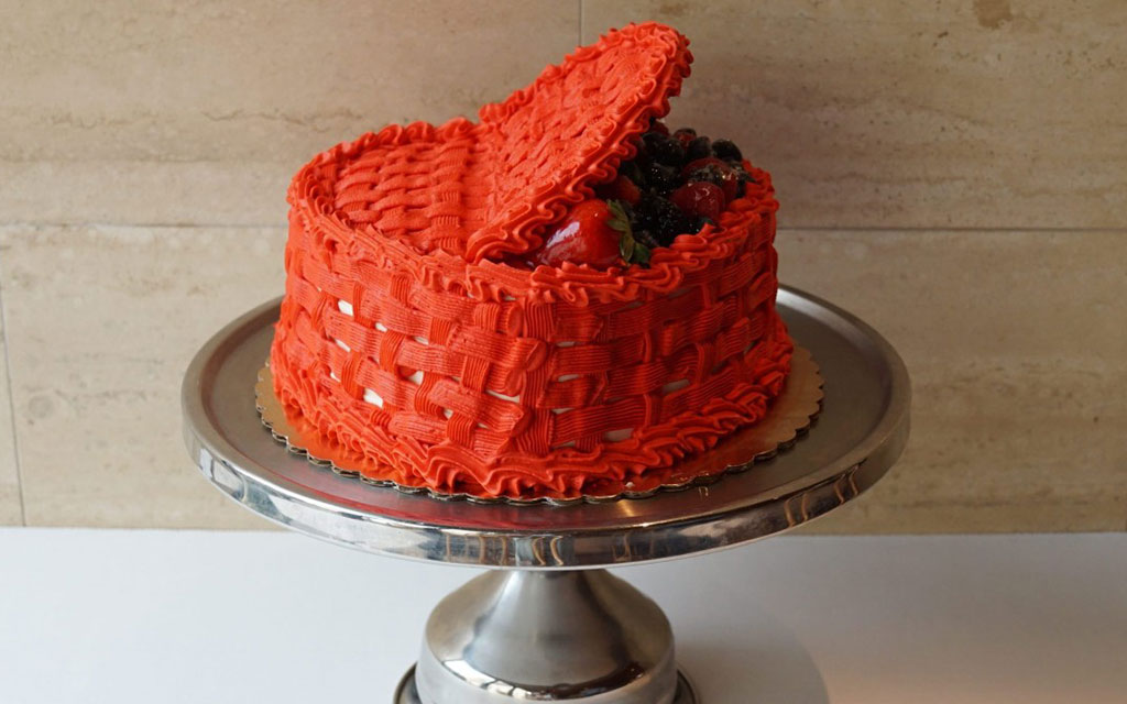 Red basketweave buttercream cake topped with fresh strawberries and berries on silver cake stand, elegant valentine's day dessert ideas