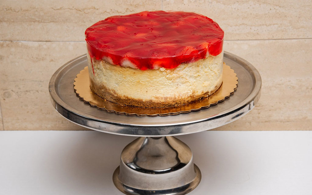 Spring dessert ideas featuring classic strawberry cheesecake with fresh strawberry glaze and graham crust