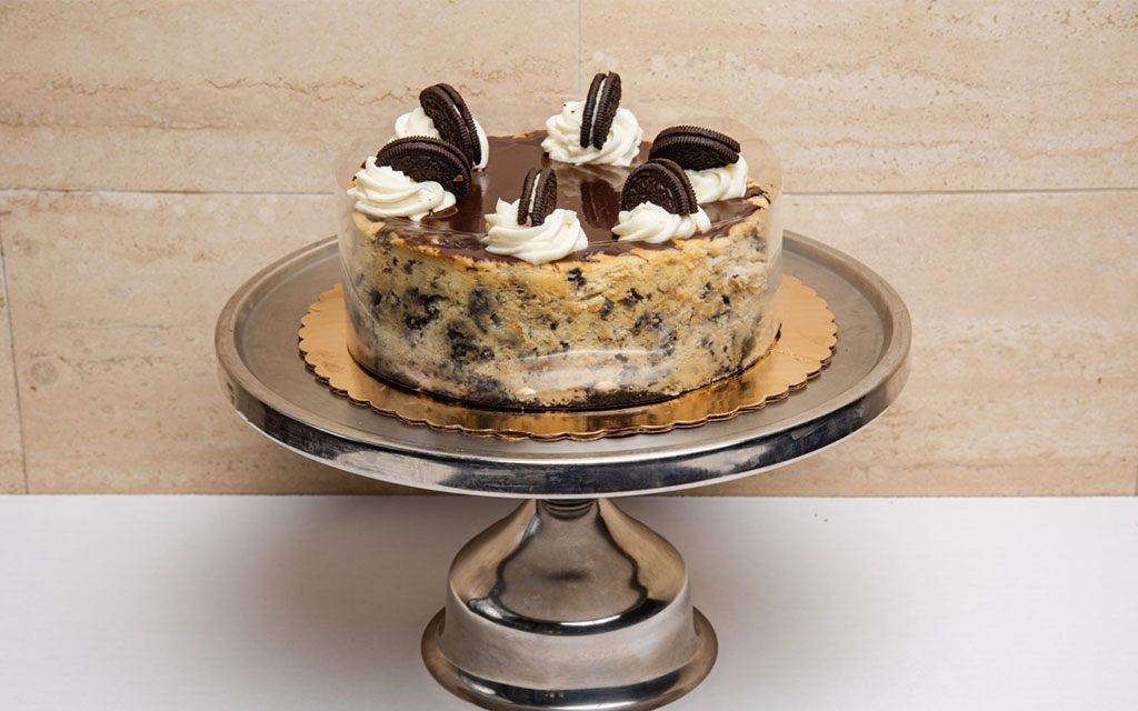 Best Easter desserts cookies and cream cheesecake with whipped cream and cookie pieces on elegant cake stand