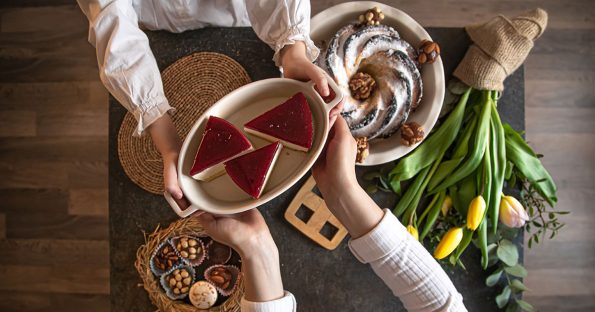 Best Easter desserts featuring raspberry tart, chocolate bundt cake, and mini treats on spring table with yellow tulips