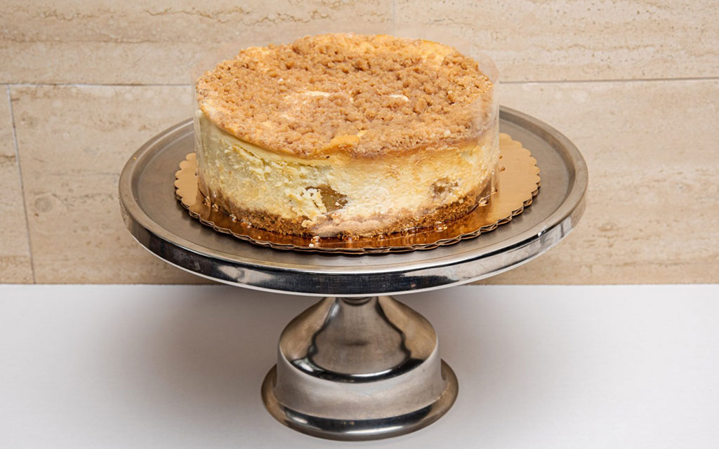 Apple crumb cheesecake on silver pedestal, gourmet fall dessert idea for entertaining