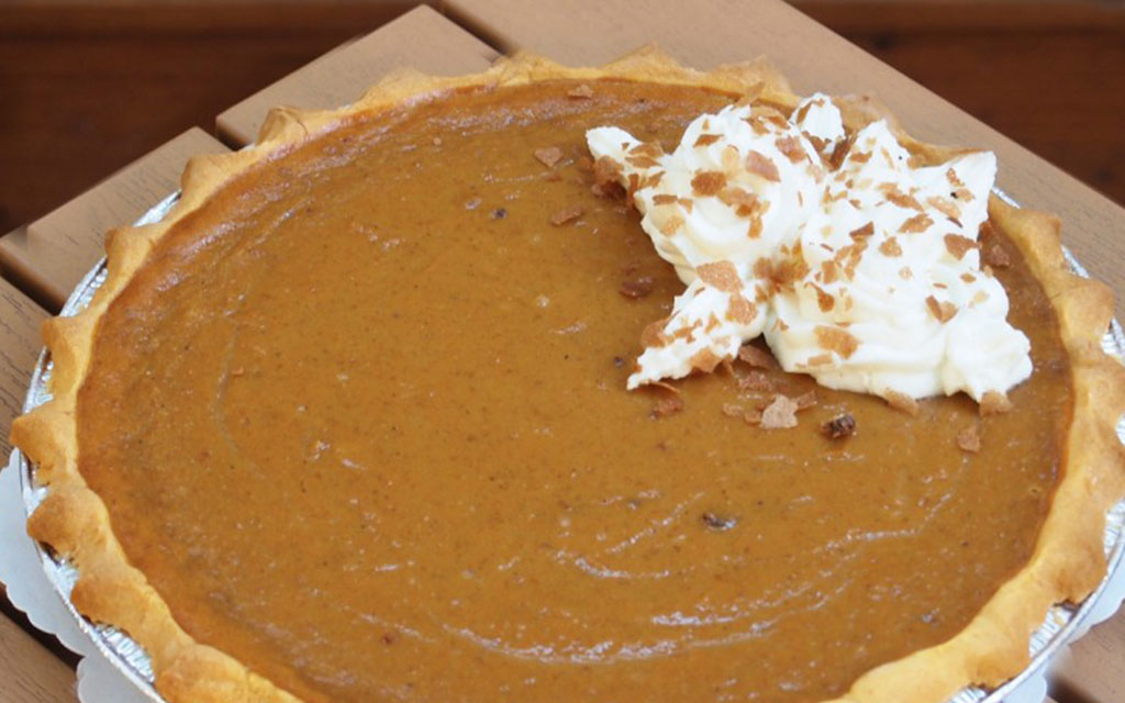 Homemade pumpkin pie with whipped cream topping, a classic fall dessert idea