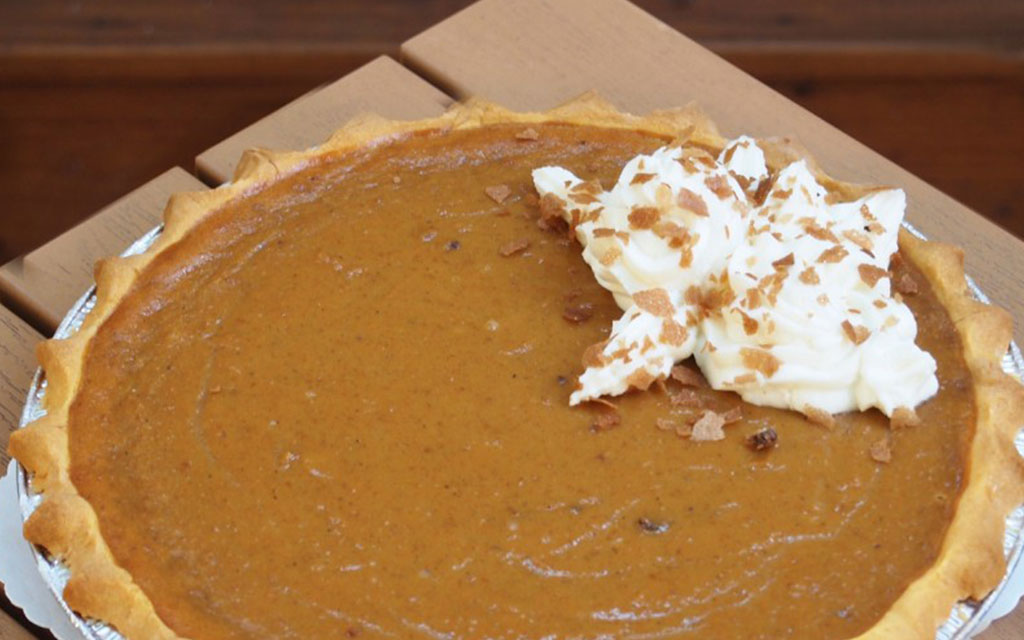 Seasonal desserts for Thanksgiving featuring classic pumpkin pie with flaky crust and whipped cream topping