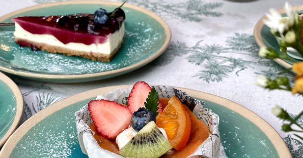 Spring dessert ideas featuring berry cheesecake bar and fresh fruit tart with strawberries, blueberries, and citrus