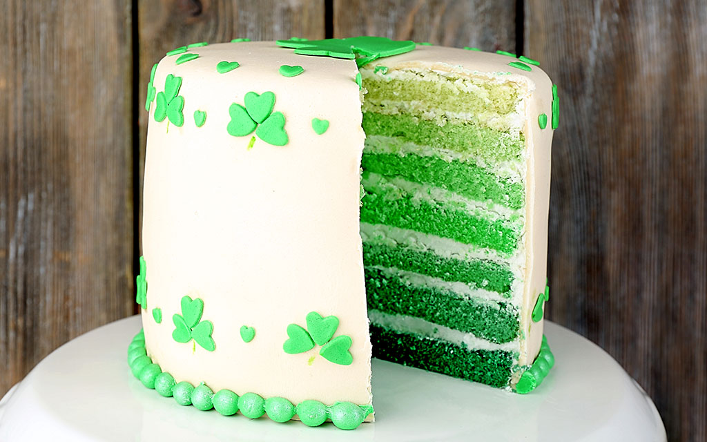 St Patrick's Day dessert ideas featuring ombre green layer cake with shamrock decorations and cream cheese frosting