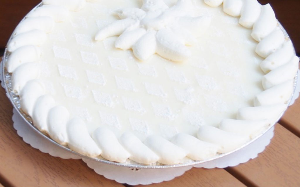 Key lime pie with whipped cream topping, a refreshing no-bake summer dessert idea for outdoor parties