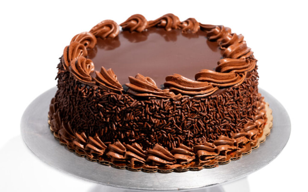 Flourless chocolate cake with chocolate buttercream frosting, a rich gluten-free winter dessert idea for celebrations