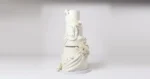 Five-tier white wedding cake by Mia's Brooklyn Bakery with draped swags and handmade sugar roses