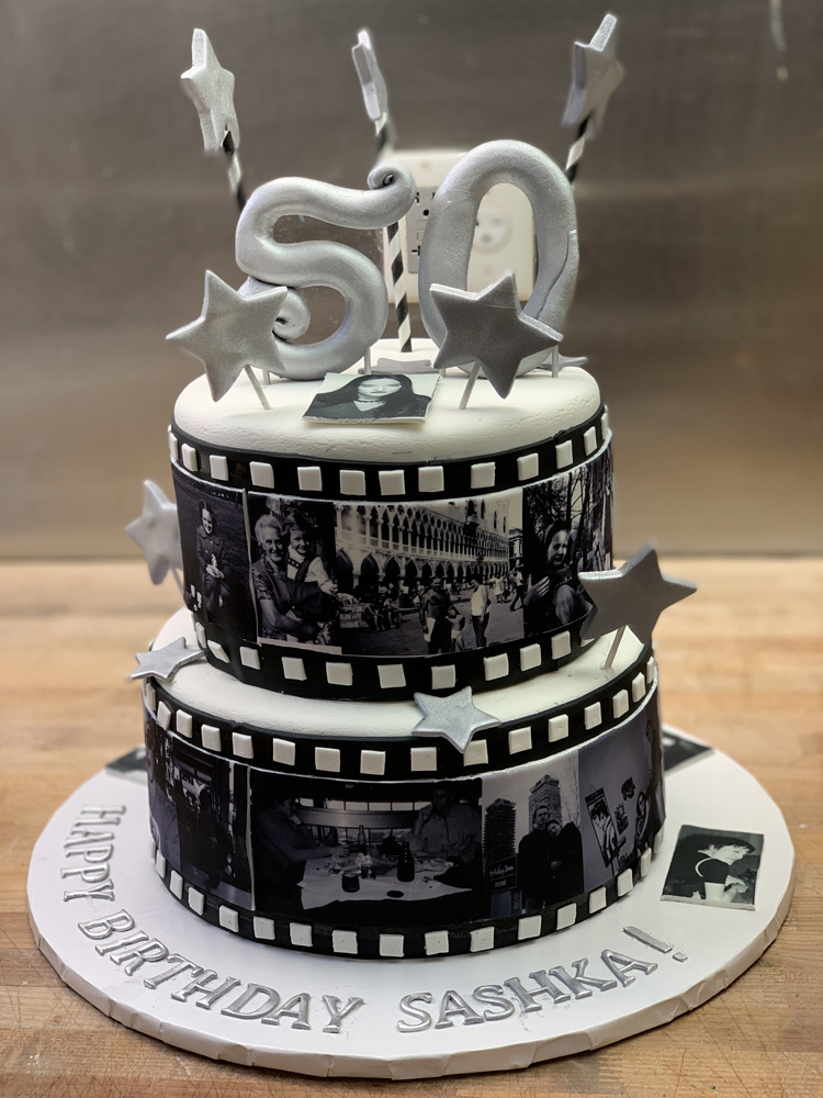 Movie reel cake I made for my sister's (covid safe) tiny wedding this past  August. Each film square has an icon from either a famous movie or one of  their favorites. :